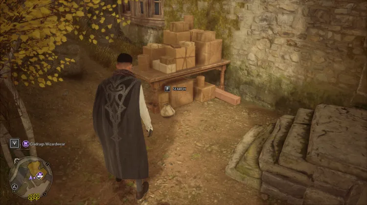 Located outside the house beside the pile of boxes.